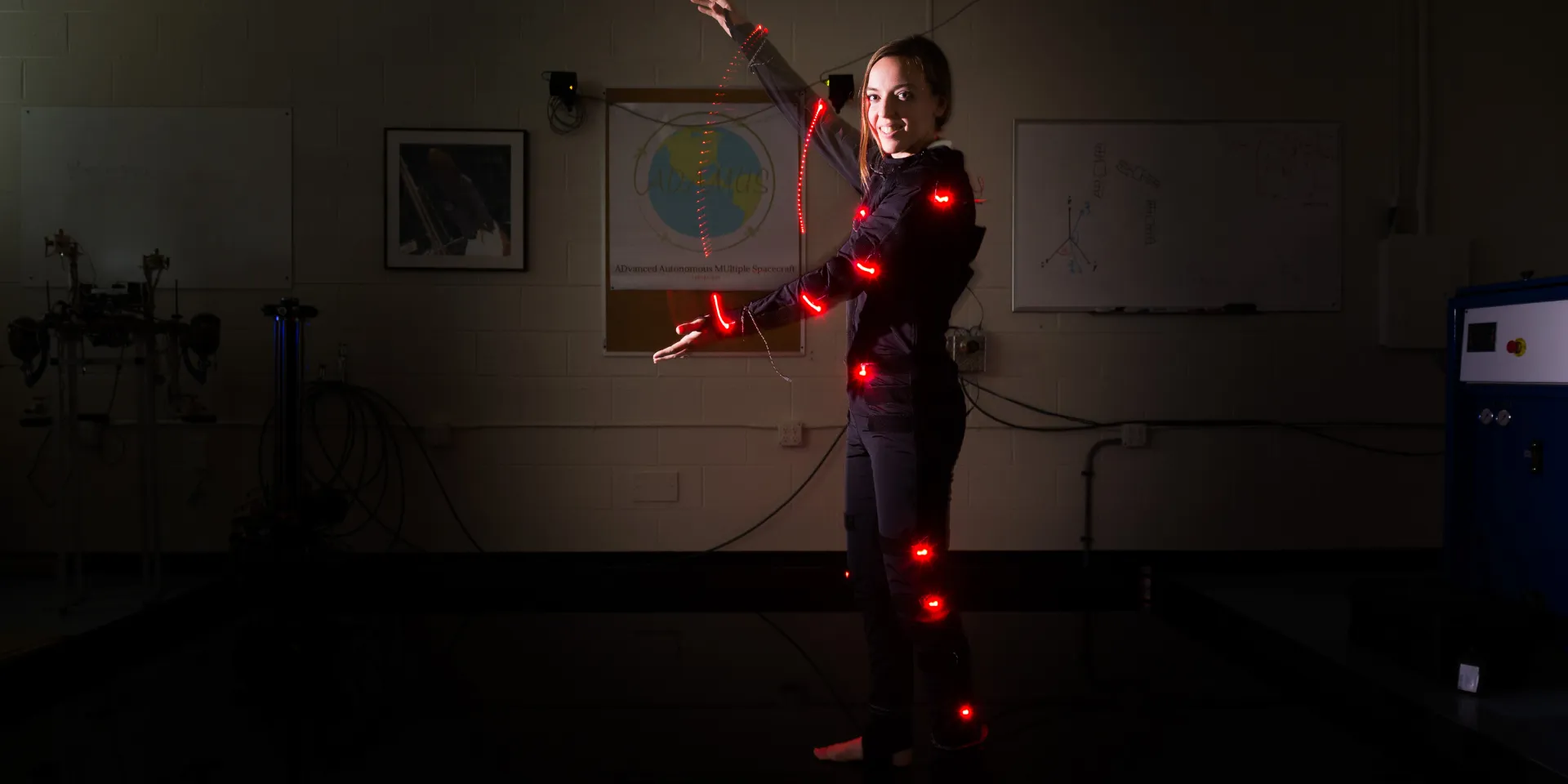 Engineering student does the Gator Chomp, creating light trails.