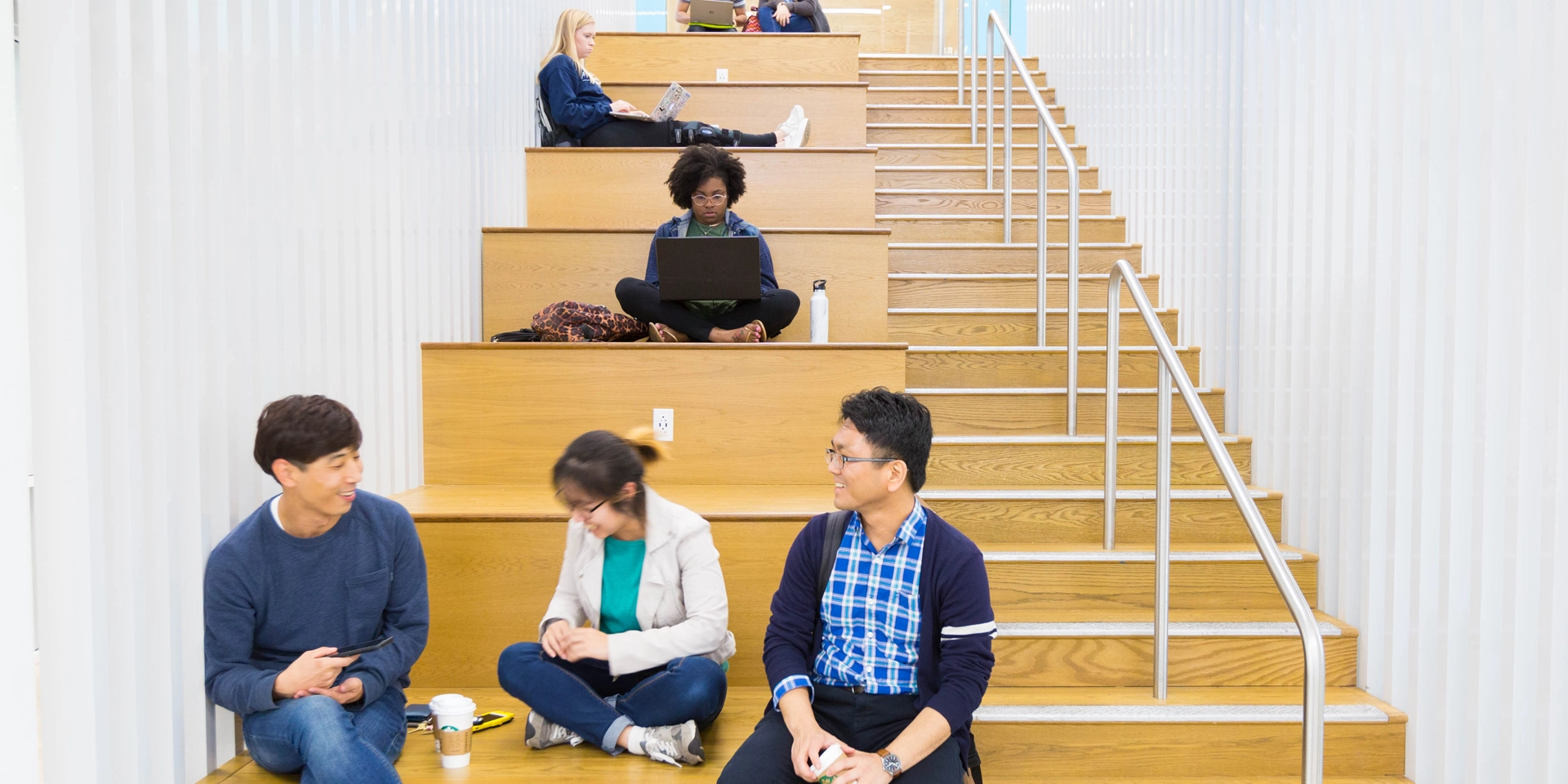 students resting at the stairs