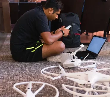 student working on drones