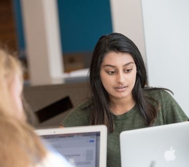 two students studying at library 