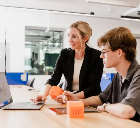 Professor and student looking at computer