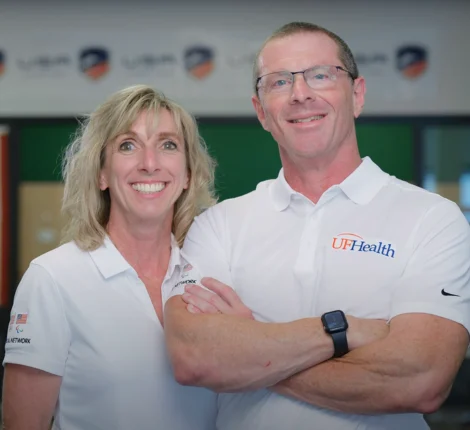 Two UF Health workers posing in front of camera.