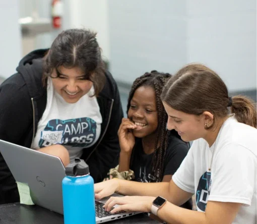 Hey Chatbot, tell me how kids can learn about AI Three children having fun while using a laptop
