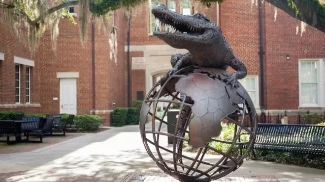 statue of gator on globe