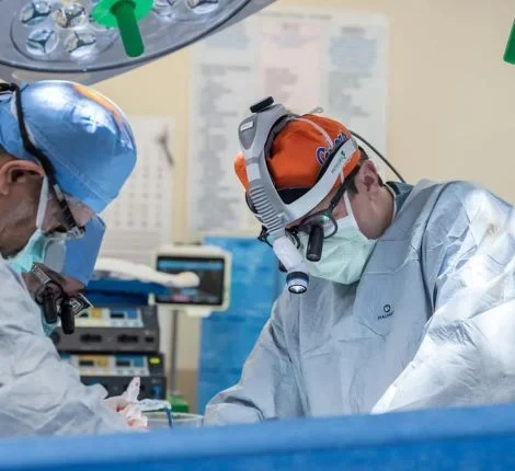 Two doctors perform a surgery.