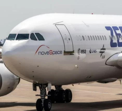 The front of a plane taxiing on a runway.