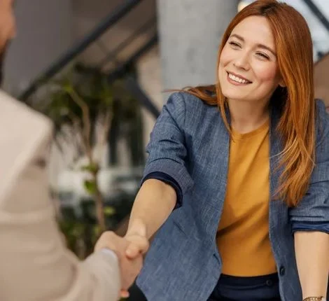 firstimpression a woman shakes hands with her employer and smiles