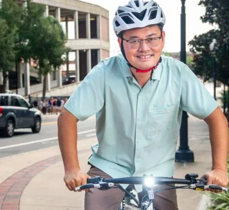 jacob Xiang Jacob Yan on a bicycle on UF's campus